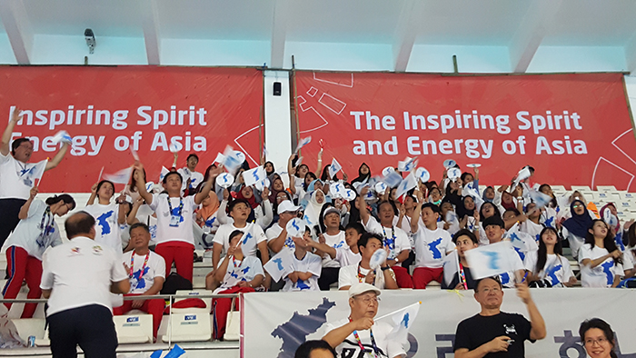  
South and North Koreans and Indonesians cheer for the Unified Korea athletes at the Gelora Bung Karno Aquatic Stadium, Jakarta. 
